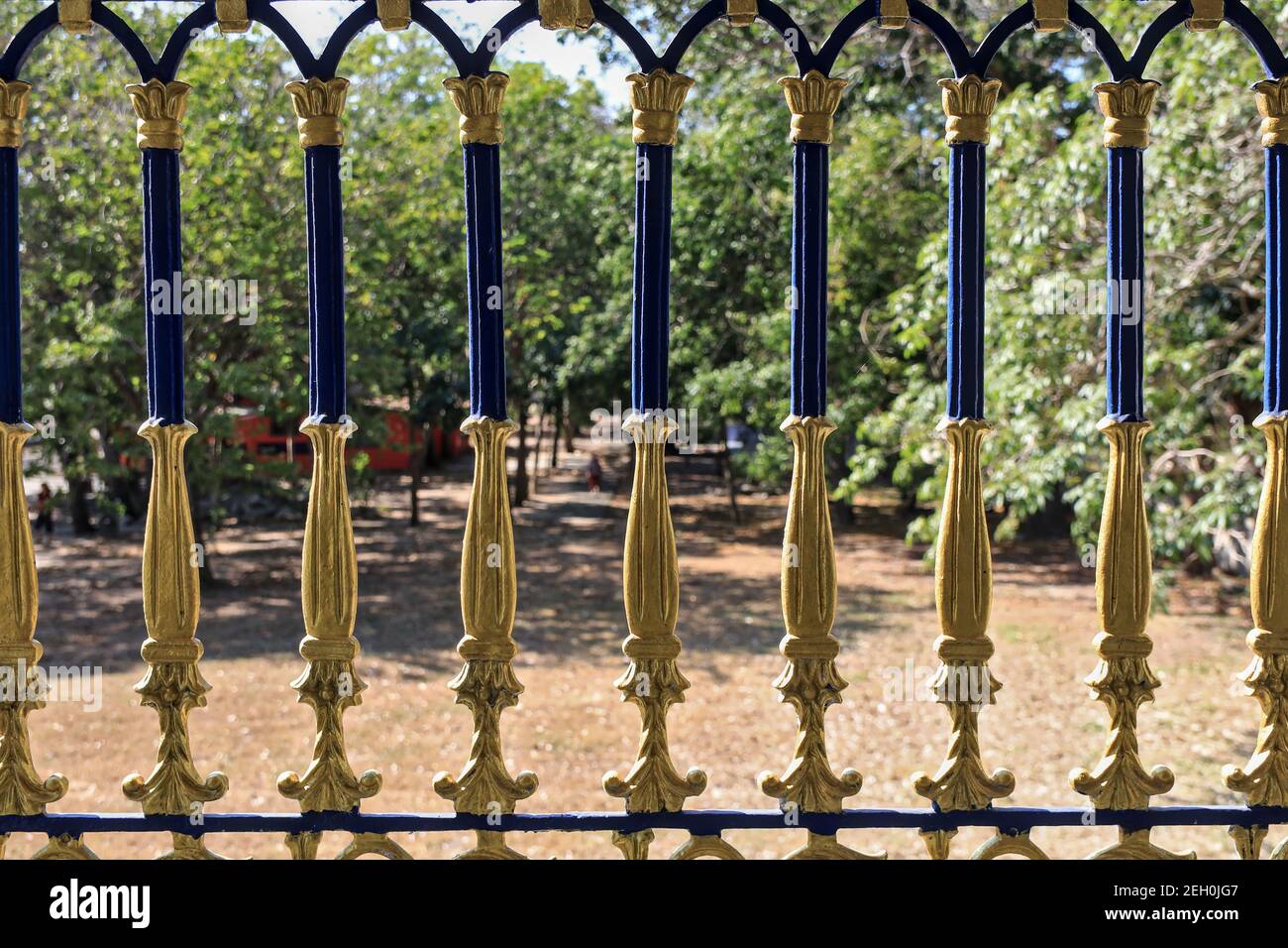 Beautiful fence balustrade with a blurred focus background in green of the trees. Stock Photo