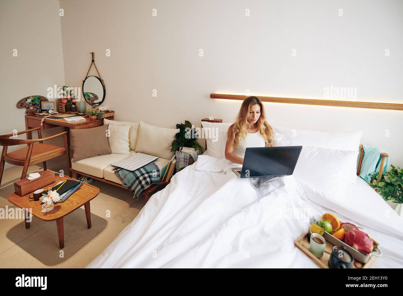 Woman working remotely from home Stock Photo