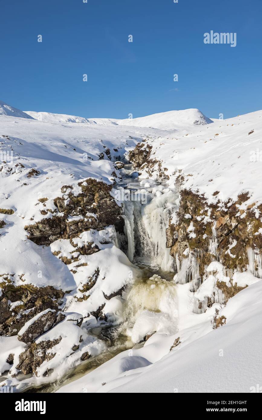 The Tail Burn in winter , the stream coming from the remote Loch Skeen  which cascades into the Grey Mares Tail waterfall further downstream Stock Photo
