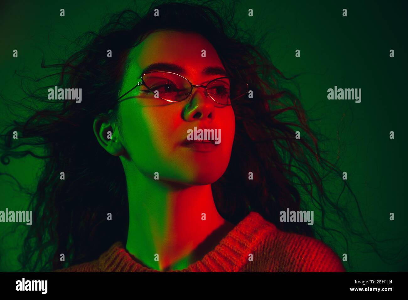 Contented. Caucasian woman's portrait isolated on green studio ...