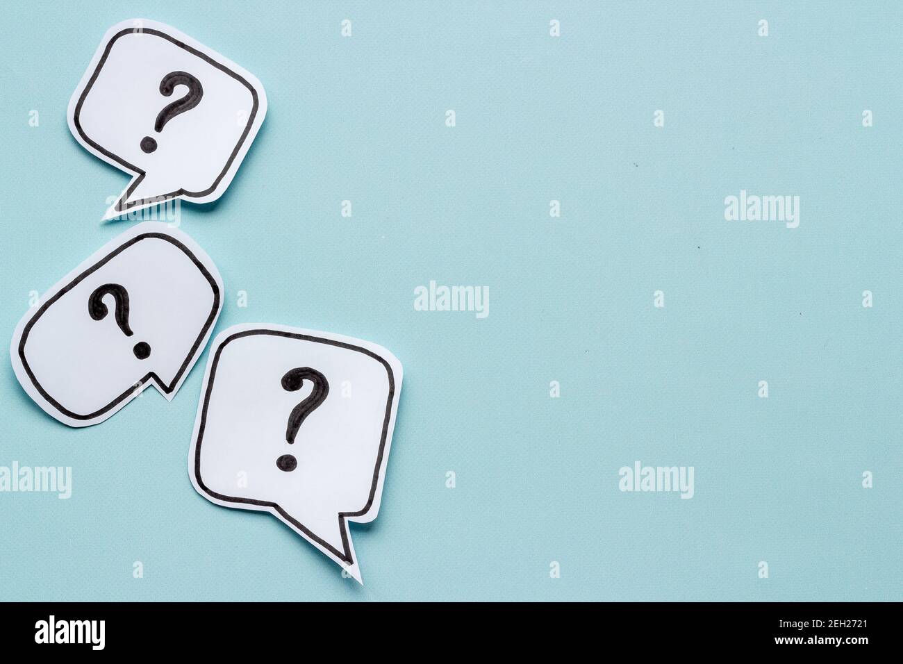 Ask question concept. Question mark on speech bubbles, top view Stock Photo
