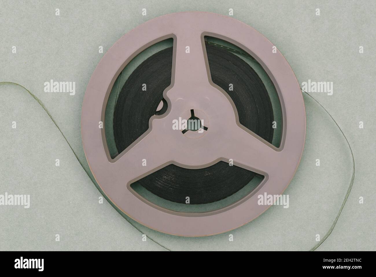 Round film reel. Gray bobbin close-up. The concept of watching an old ...