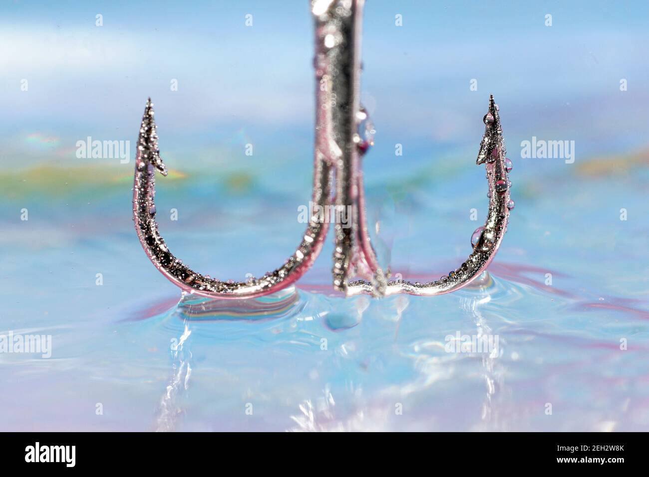 Fishhook Metal shiny fishhook over the water surface Stock Photo - Alamy
