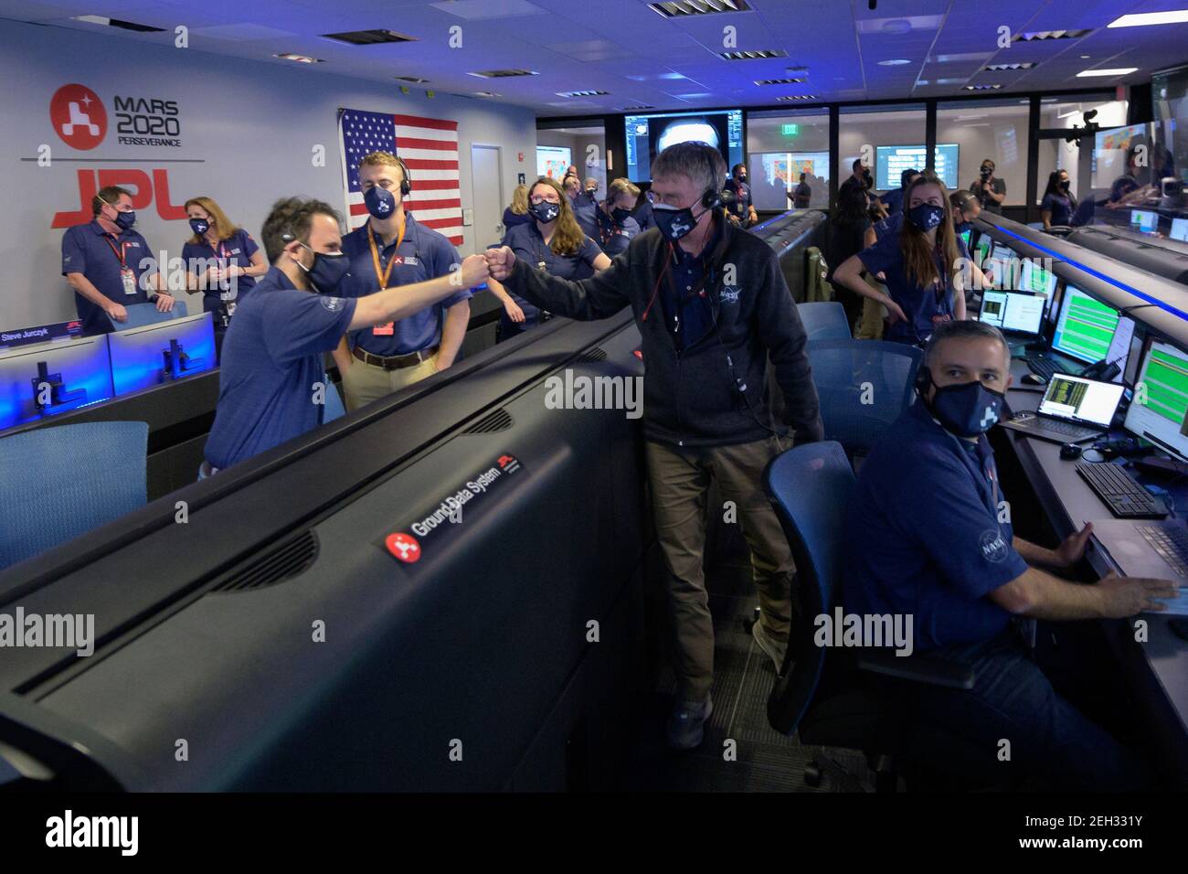 Pasadena, California. 18th Feb 2021. Members of NASA's Perseverance rover team react in mission control after receiving confirmation the spacecraft successfully touched down on Mars, on Thursday, February 18, 2021, at NASA's Jet Propulsion Laboratory in Pasadena, California. A key objective for Perseverance's mission on Mars is astrobiology, including the search for signs of ancient microbial life. Credit: UPI/Alamy Live News Stock Photo