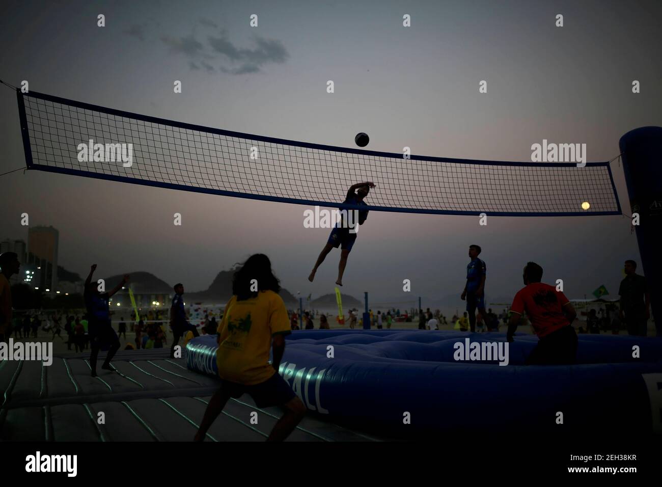 2016 Rio Olympics - Rio de Janeiro, Brazil - 17/08/2016. Tourists play  bossaball, a combination of volleyball, football and gymnastics, played on  an inflatable court featuring a trampoline on each side of