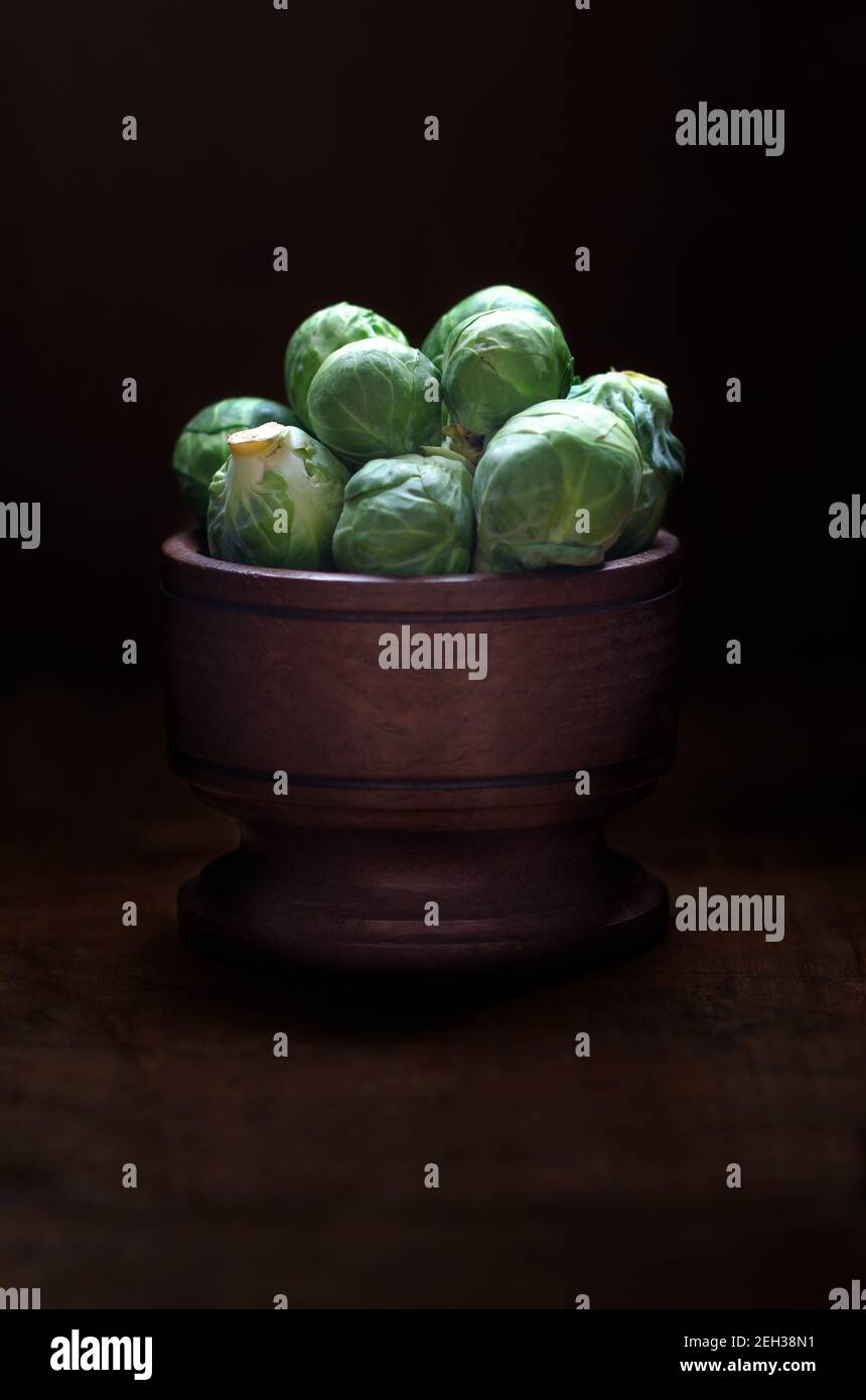 Brussels sprouts in a wooden bowl. Stock Photo