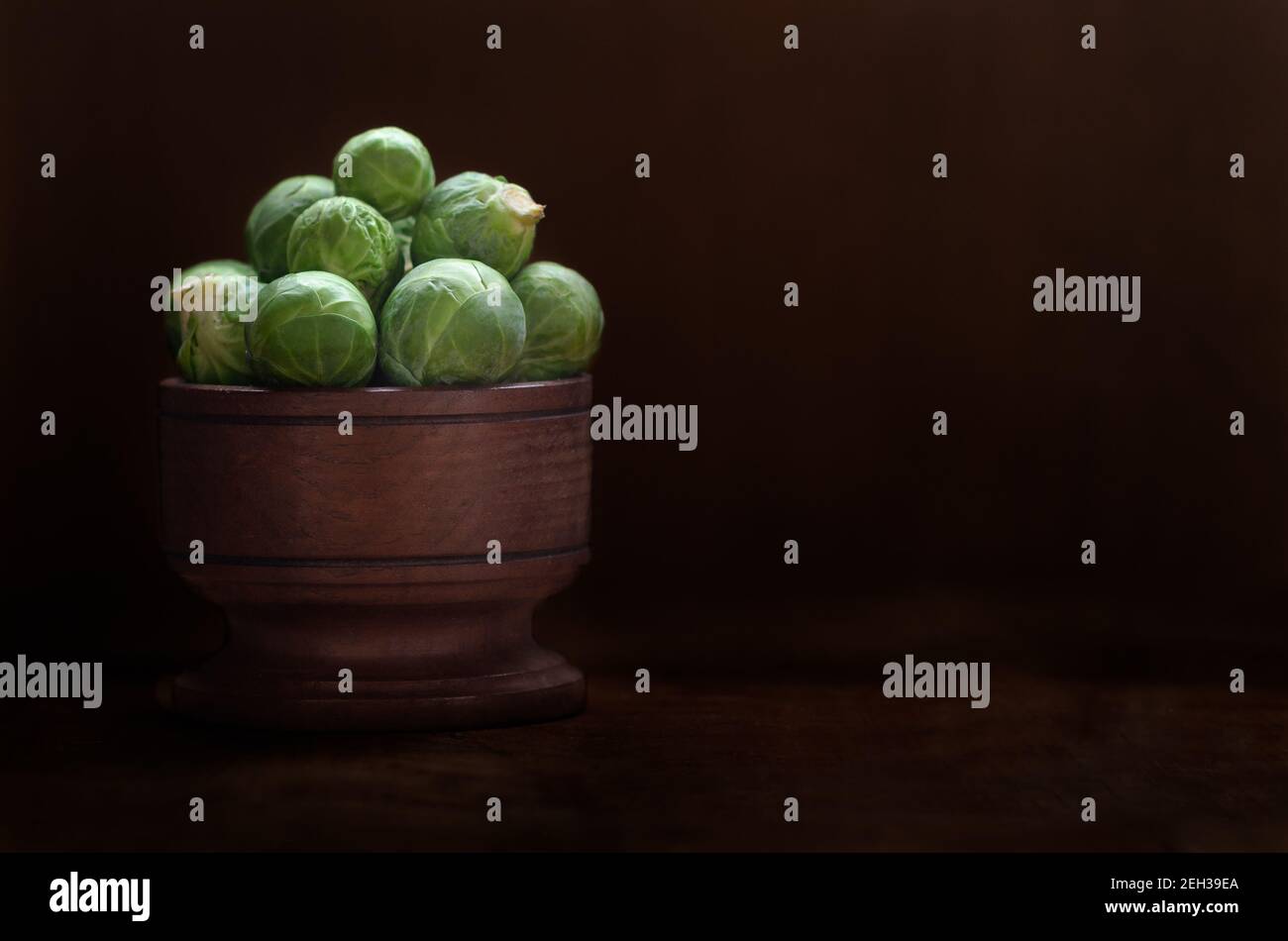 Brussels sprouts in a wooden bowl. Stock Photo