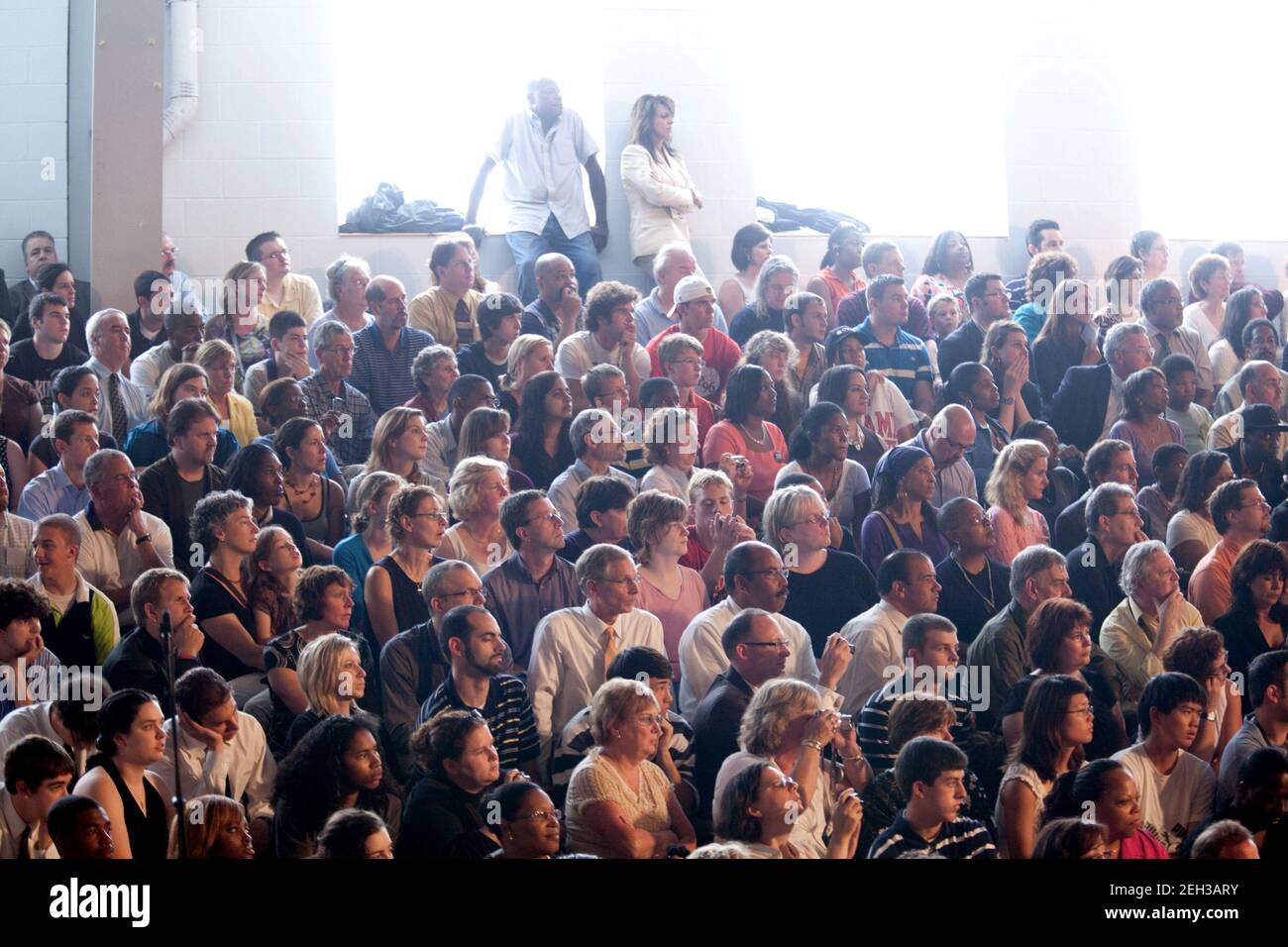 Audience members listen as President Barack Obama speaks at a town hall meeting at Shaker Heights High School in Cleveland, Ohio, on July 23, 2009. Stock Photo