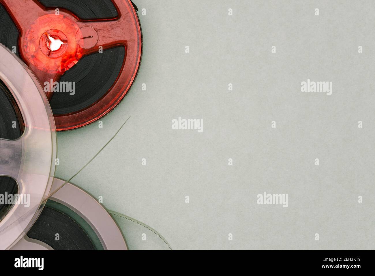 Old film reels on a green background with copy space. Magnetic tape. Top view, flat lay. Stock Photo