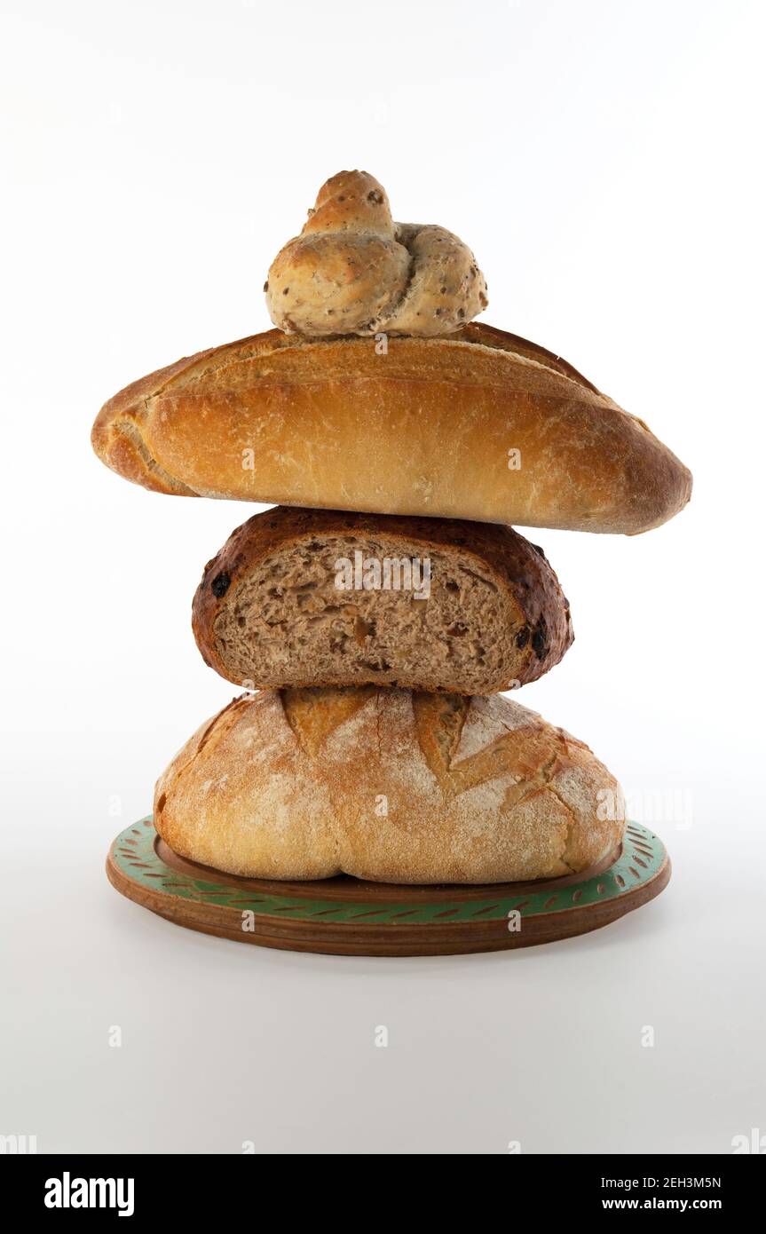 Assorted breads on board against white background Stock Photo - Alamy