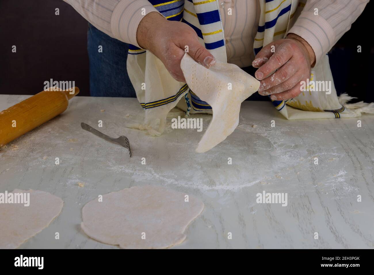 Orthodox Jewish man prepare for the Jewish holiday day in hand made kosher matzah prepare Stock Photo