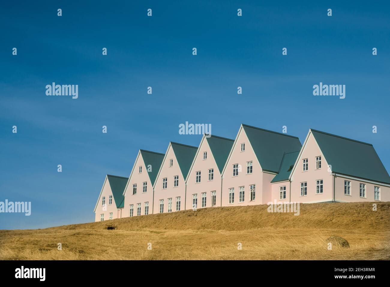 Pink Painted Traditional Scandinavian Style Hotel in a Rural Location  with Blue Sky Stock Photo