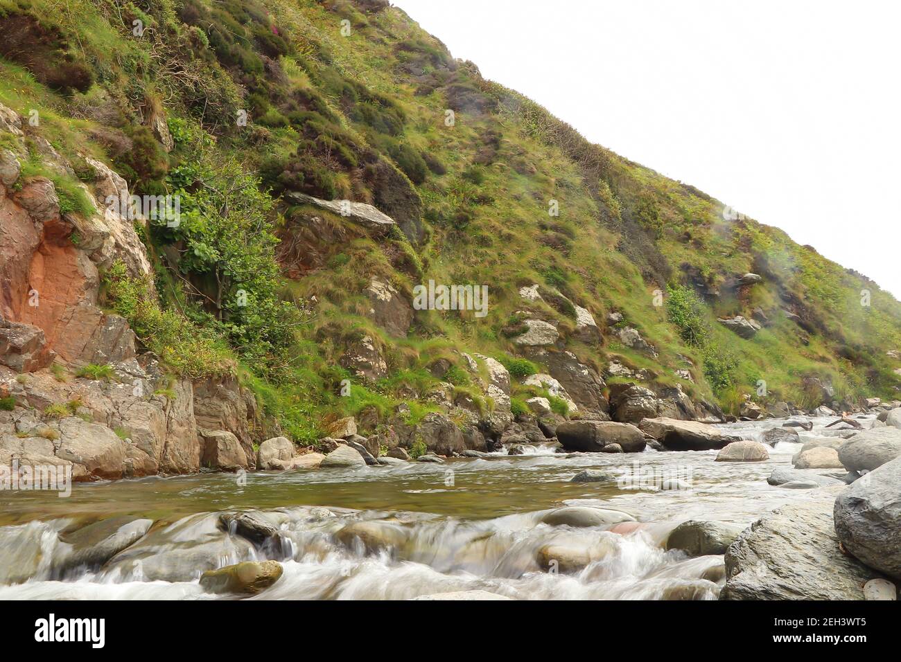 Heddon river flowing through the valley and over rocky ground Stock Photo