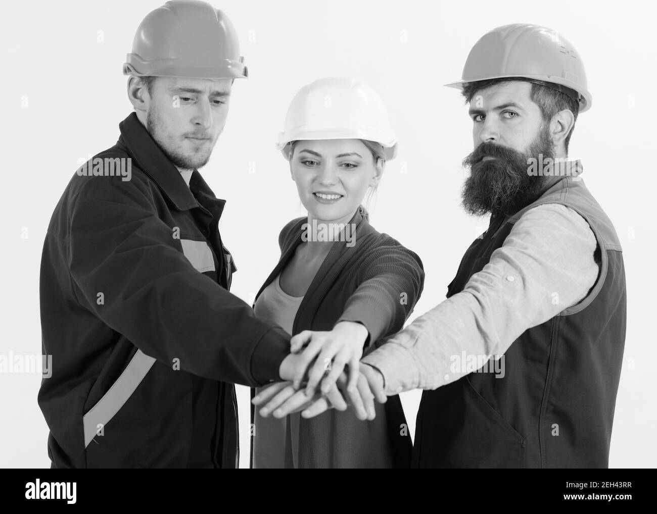 https://c8.alamy.com/comp/2EH43RR/woman-and-men-in-hard-hats-holds-hands-together-team-of-architects-builders-ready-to-work-isolated-white-background-teambuilding-concept-builder-engineer-labourer-repairman-as-friendly-team-2EH43RR.jpg