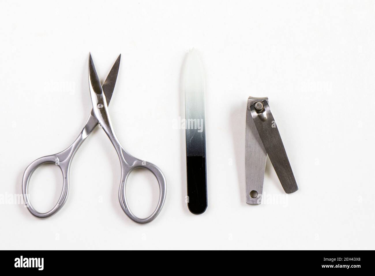 Scissors and other instruments for nails on the white background Stock Photo