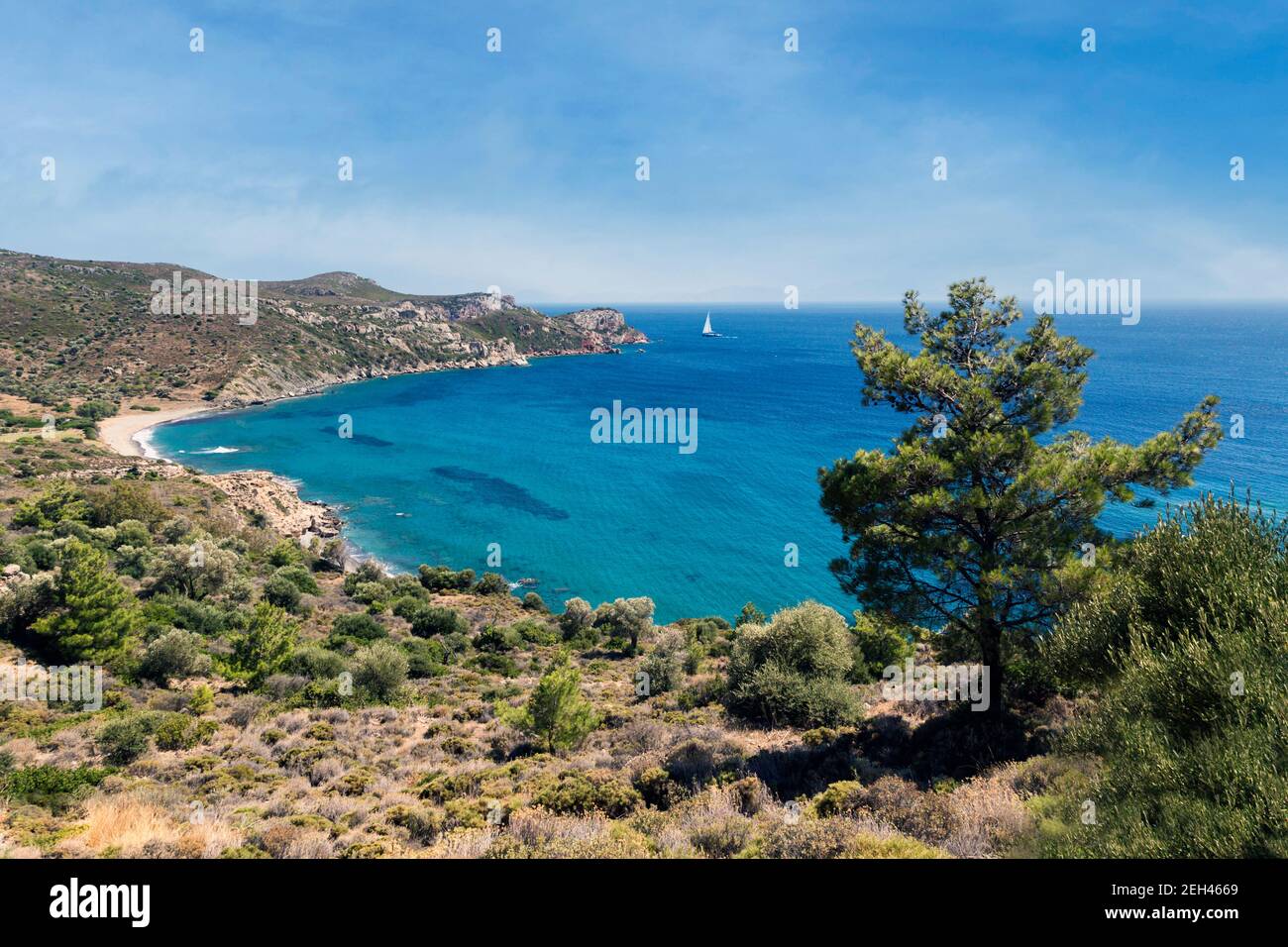 Scene on the Datca Peninsula, Mugla Province, Aegean region, Turkey.  Deserted beach with boat sailing by. Stock Photo