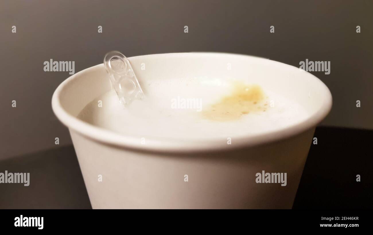 https://c8.alamy.com/comp/2EH46KR/milk-coffee-in-paper-white-glass-from-vending-coffee-machine-with-plastic-spoon-stirrer-close-up-2EH46KR.jpg