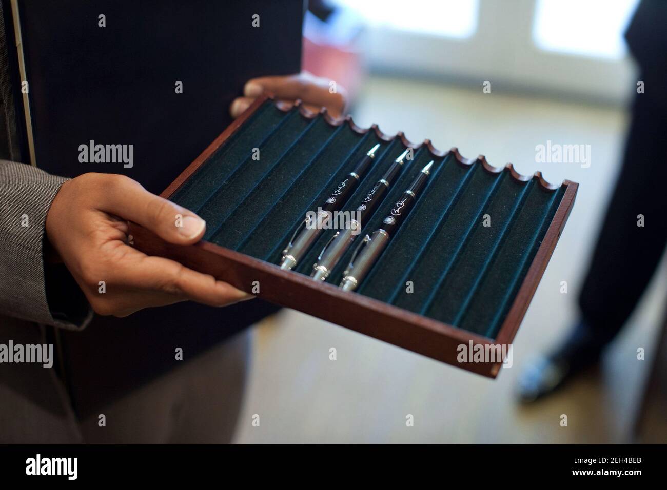 A staff member delivers the pens that President Barack Obama will use to sign the Council of Environoment Quality (CEQ) Executive Order in the Oval Office, Oct. 5, 2009. Stock Photo