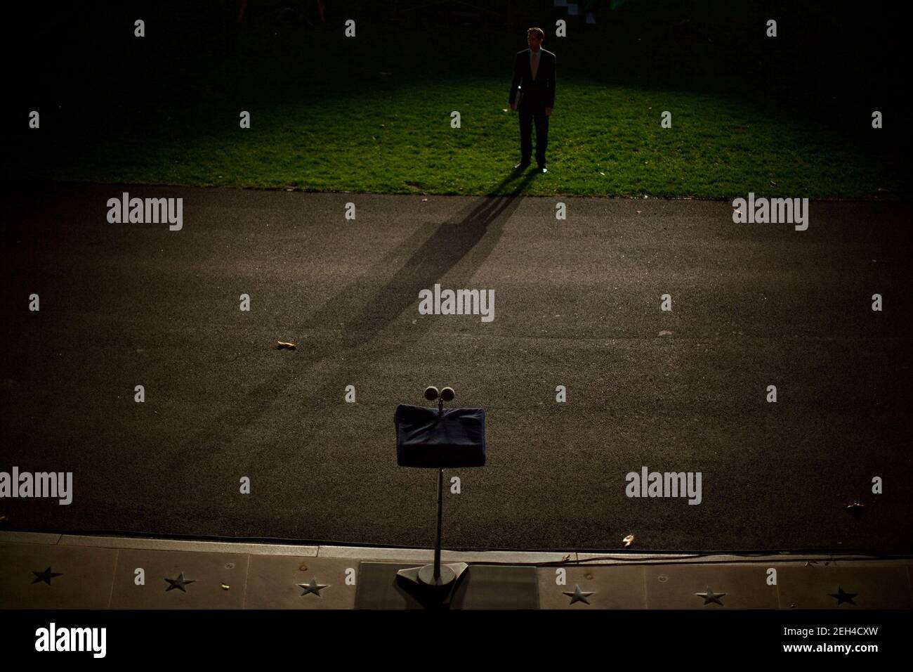 Deputy Director of Oval Office Operations Brian Mosteller's shadow is cast during a ighting test on the South Lawn of the White House, Oct.7, 2009, in preparation for the Astronomy Night event. Stock Photo