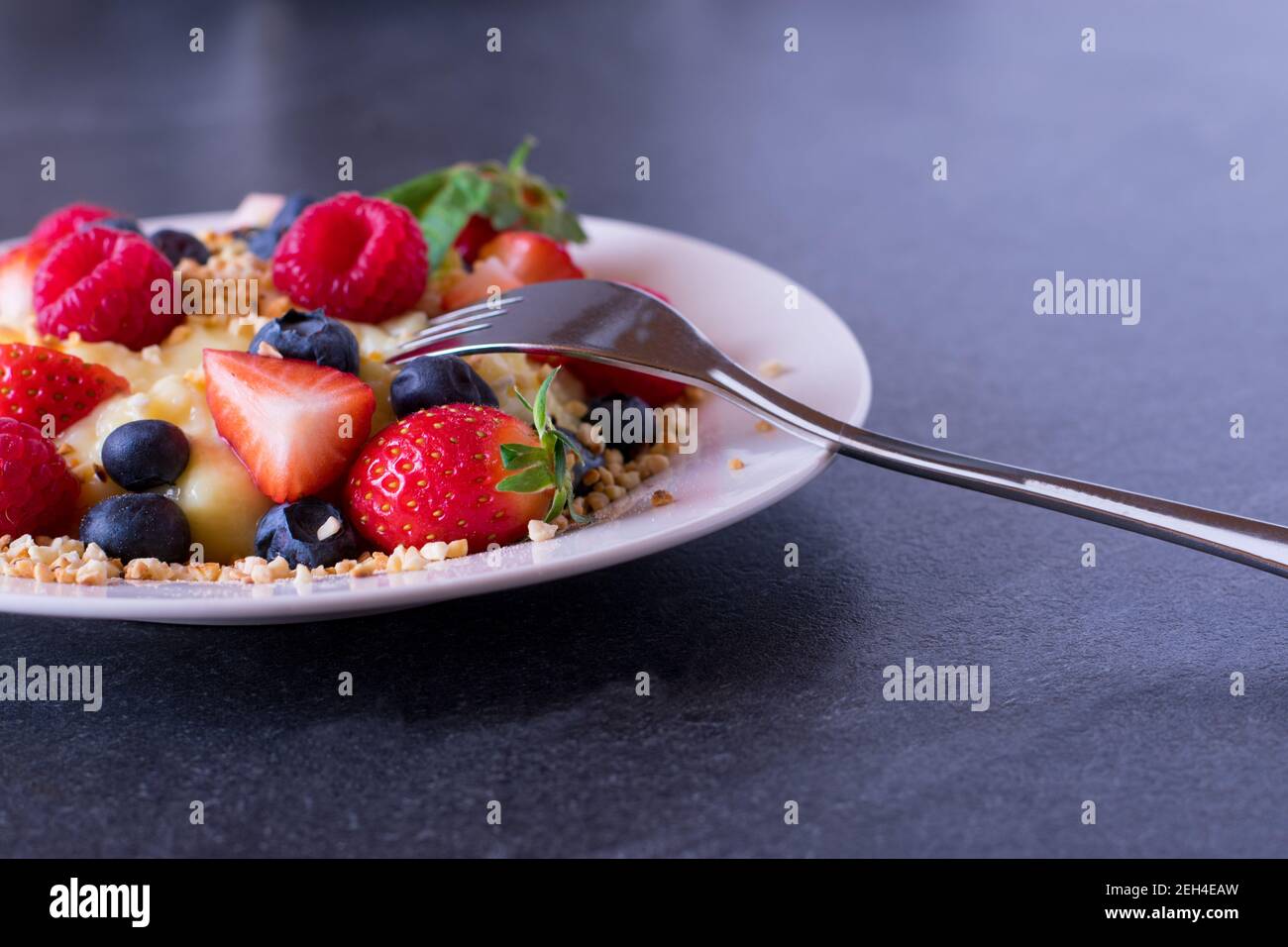 Pre Workout meal with high protein pudding, fresh berries, roasted almonds served on a plate with copy space Stock Photo