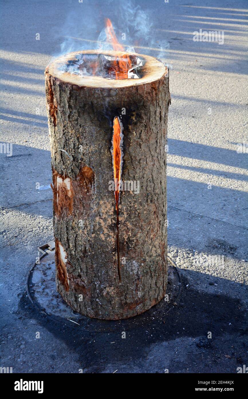 burning tree trunk - a traditional kind of open fire for events in rural areas Stock Photo