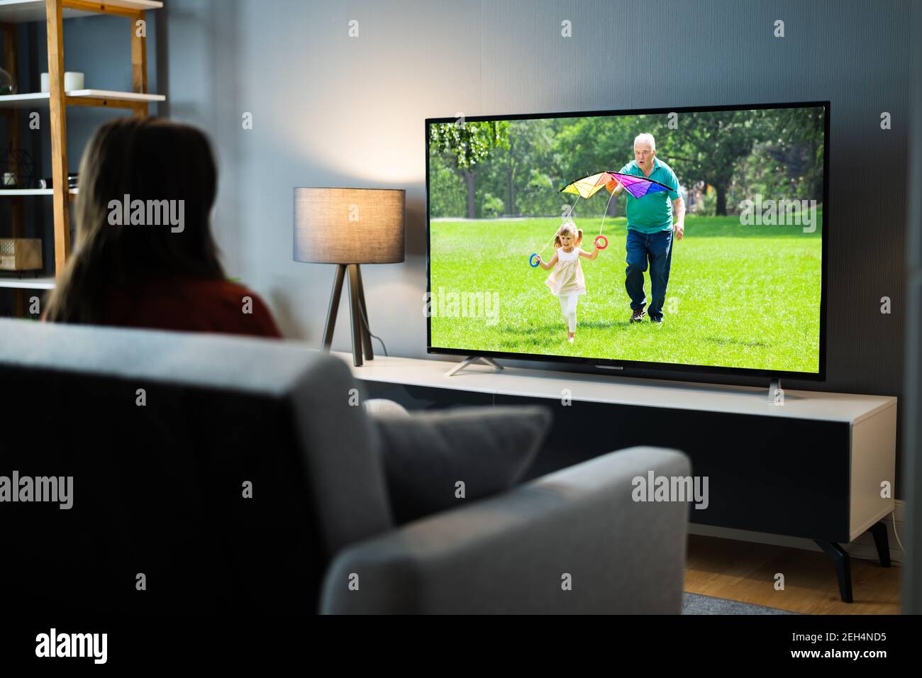Woman Watching TV Movie At House Room Stock Photo