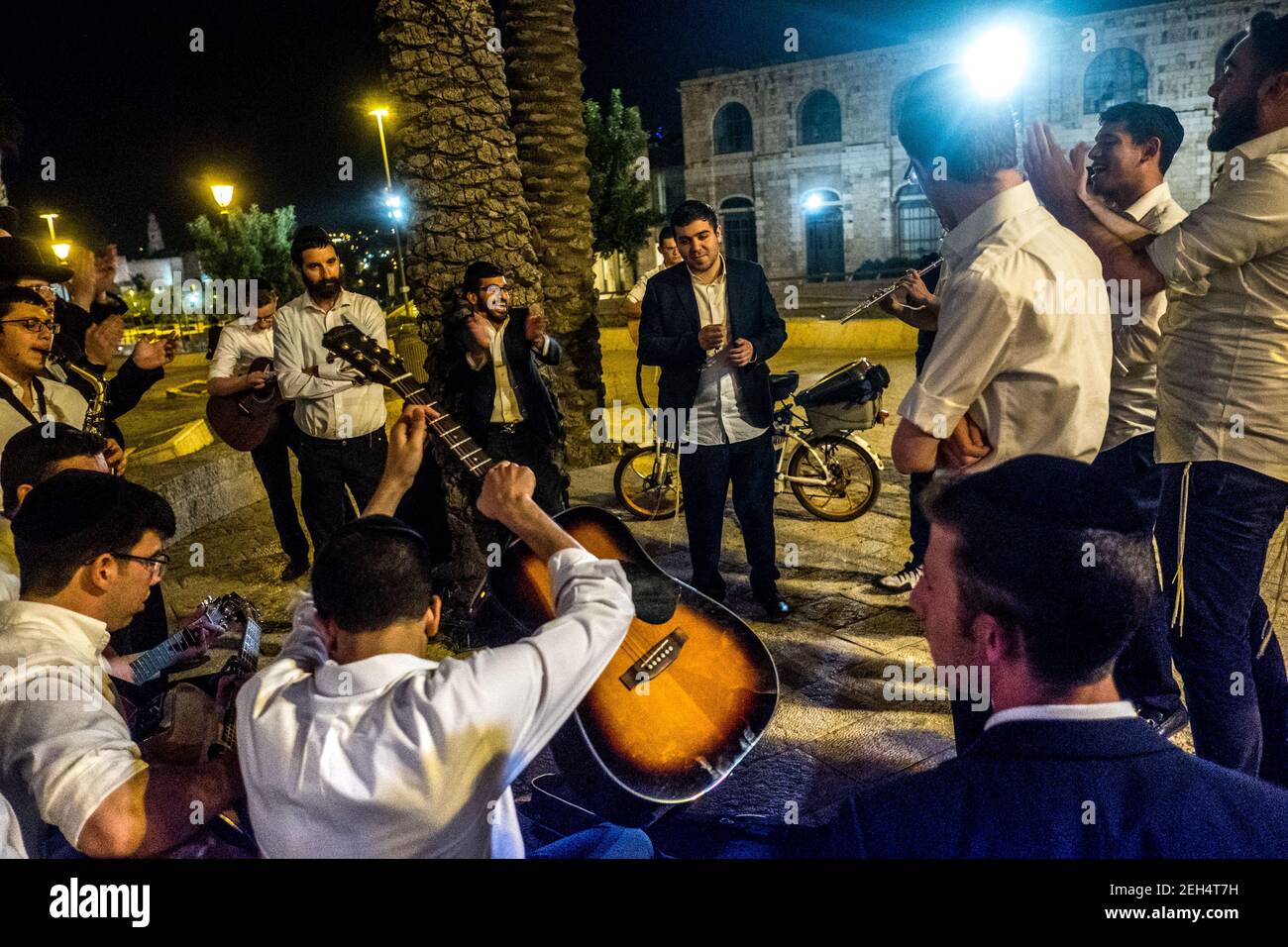 A group of young, practicing Jews play music. They meet every Friday evening at the Jaffah Gate at the foot of the old city walls for Shabbat. May 17, 2018. Jerusalem. Israel. Edit Stock Photo