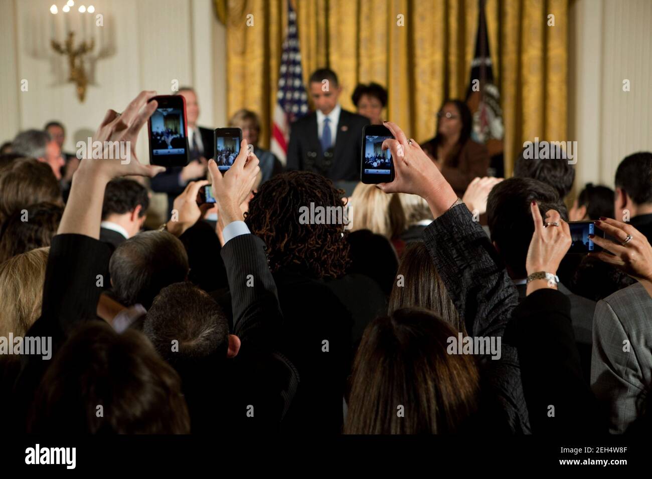 Guests take pictures during a reception commemorating the enactment of the Matthew Shepard and James Byrd Jr. Hate Crimes Prevention Act, in the East Room of the White House, Oct. 28, 2009. Stock Photo