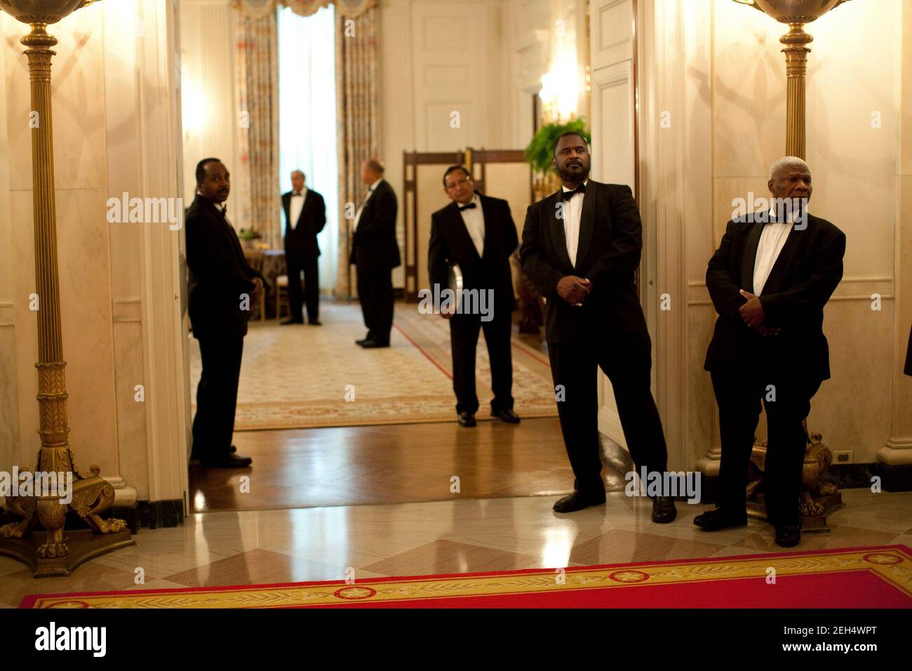 White House butlers watch as President Barack Obama makes his way towards the State Dining Room of the White House at the conclusion of a ceremony commemorating the enactment of the Matthew Shepard and James Byrd Jr. Hate Crimes Prevention Act, Oct. 28, 2009. Stock Photo