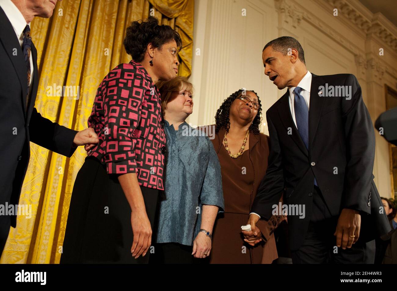 President Barack Obama greets Louvon Harris, left, Betty Byrd Boatner, right, both sisters of James Byrd, Jr., and Judy Shepard, center, mother of Matthew Shepard,  following his remarks at a reception commemorating the enactment of the Matthew Shepard and James Byrd Jr. Hate Crimes Prevention Act in the East Room of the White House, Oct. 28, 2009. Stock Photo