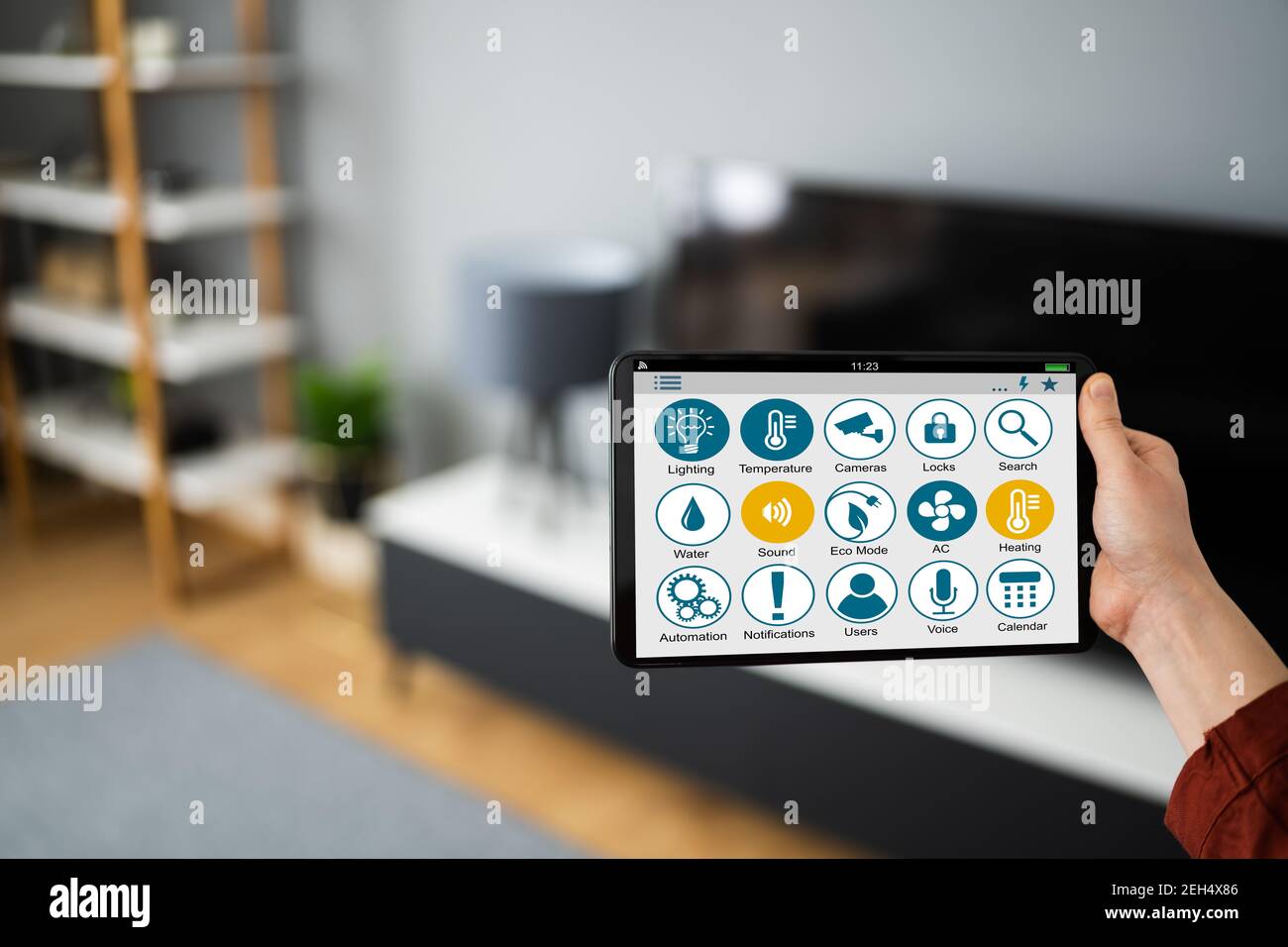 https://c8.alamy.com/comp/2EH4X86/using-house-automation-technology-and-iot-tech-gadgets-2EH4X86.jpg