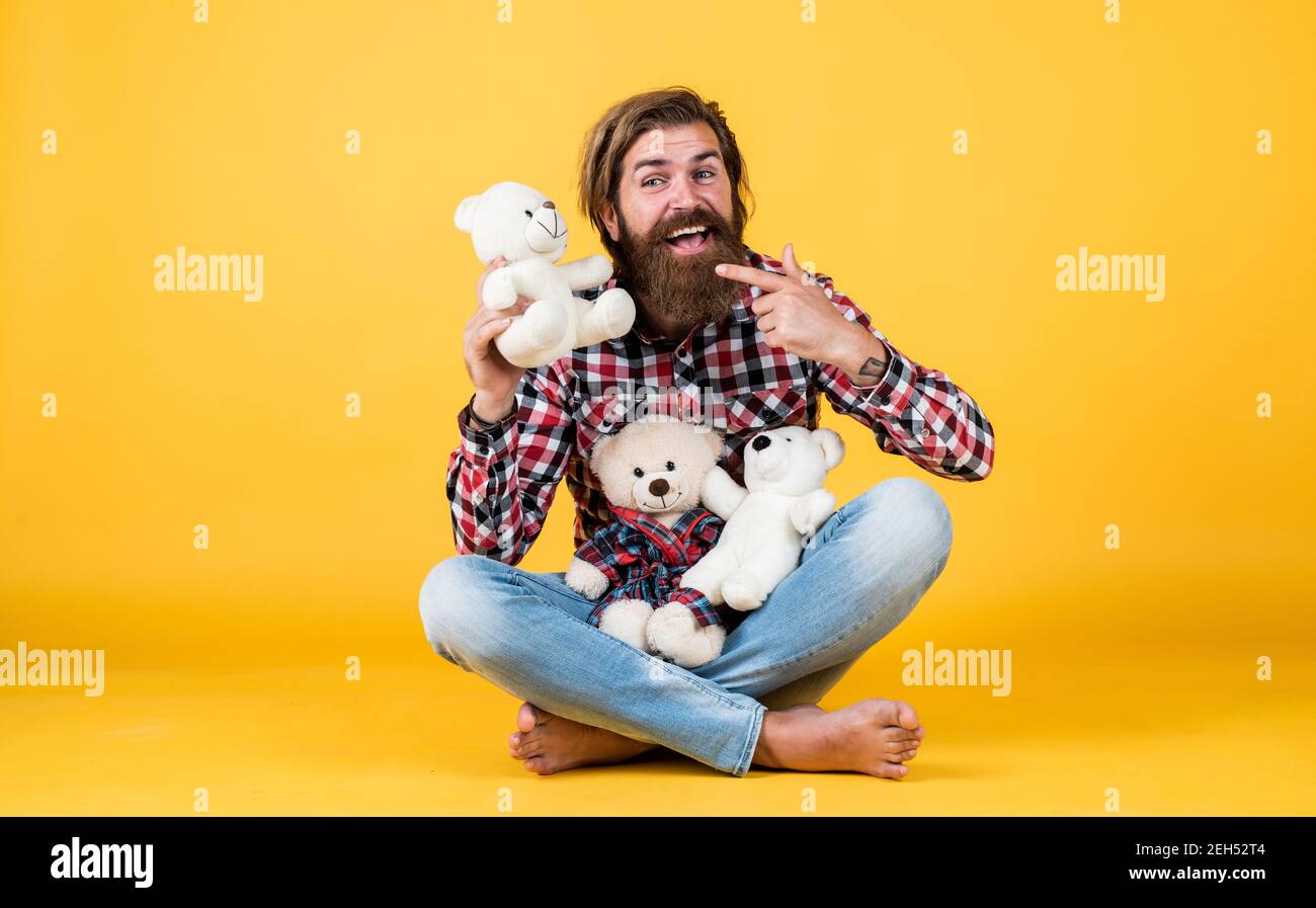 what a cute. cheerful bearded man hold teddy bear. male feel playful with bear. brutal mature hipster man play with toy. happy birthday. being in good mood. happy valentines day. Stock Photo