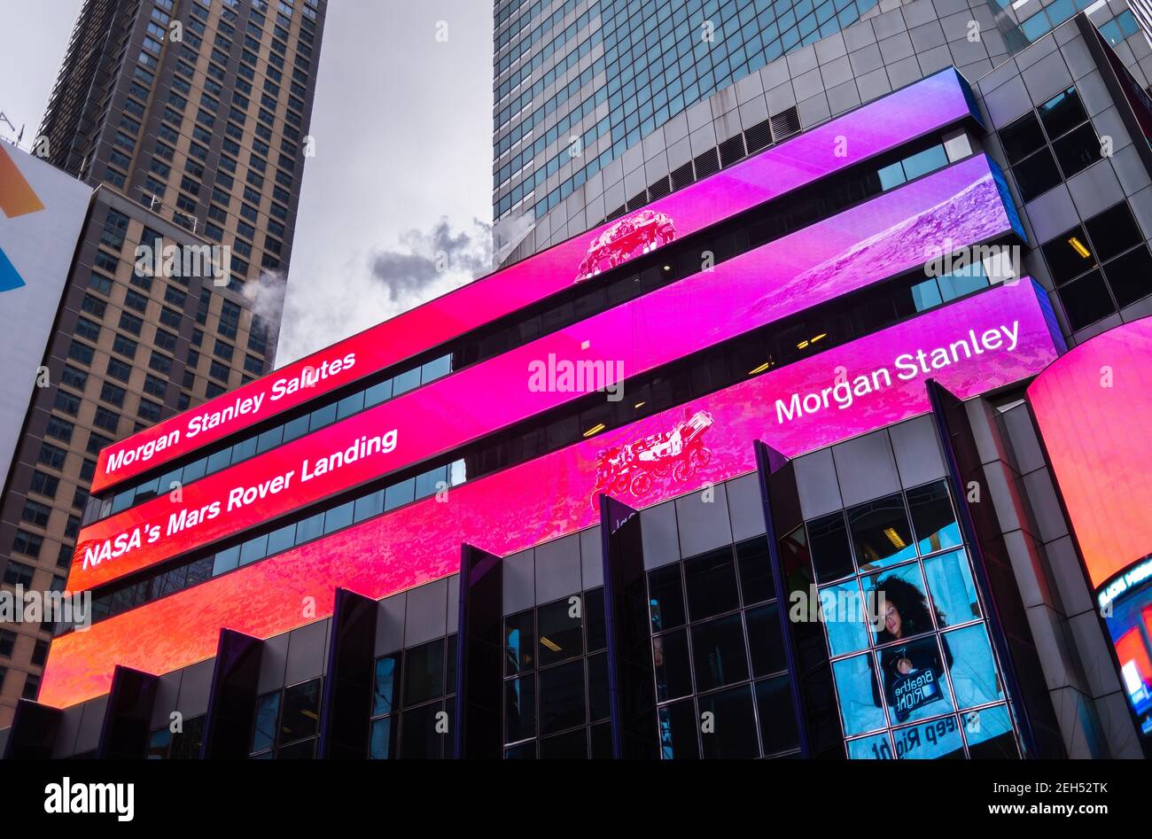 New York, USA. 18th Feb 2021. The news banner on the Morgan Stanley video board celebrates the successful landing of the NASA Mars Perseverance rover on the surface of the Red Planet February 18, 2021 in New York City, New York. Perseverance will search for signs of ancient microbial life. Credit: Planetpix/Alamy Live News Stock Photo