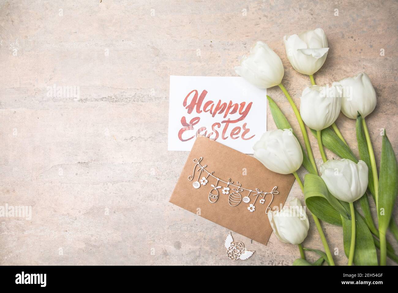 Easter eggs and white tulips on gray background. Top view flat lay ...