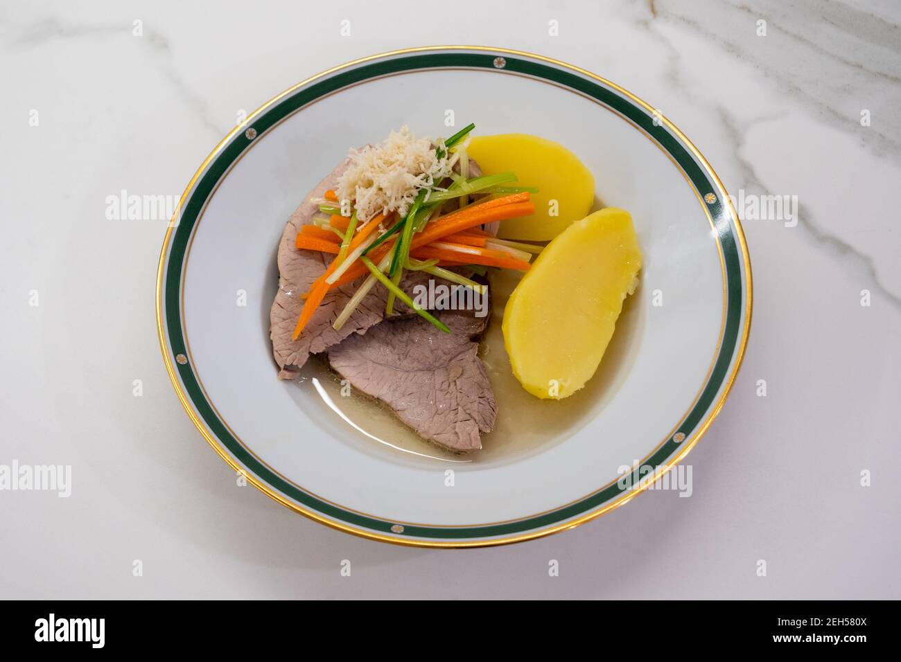 Styrian Stewed Pork with Root Vegetable Julienne of Carrots, Leeks, Horseradish and Potatoes called Steirisches Wurzelfleisch in Austria Stock Photo