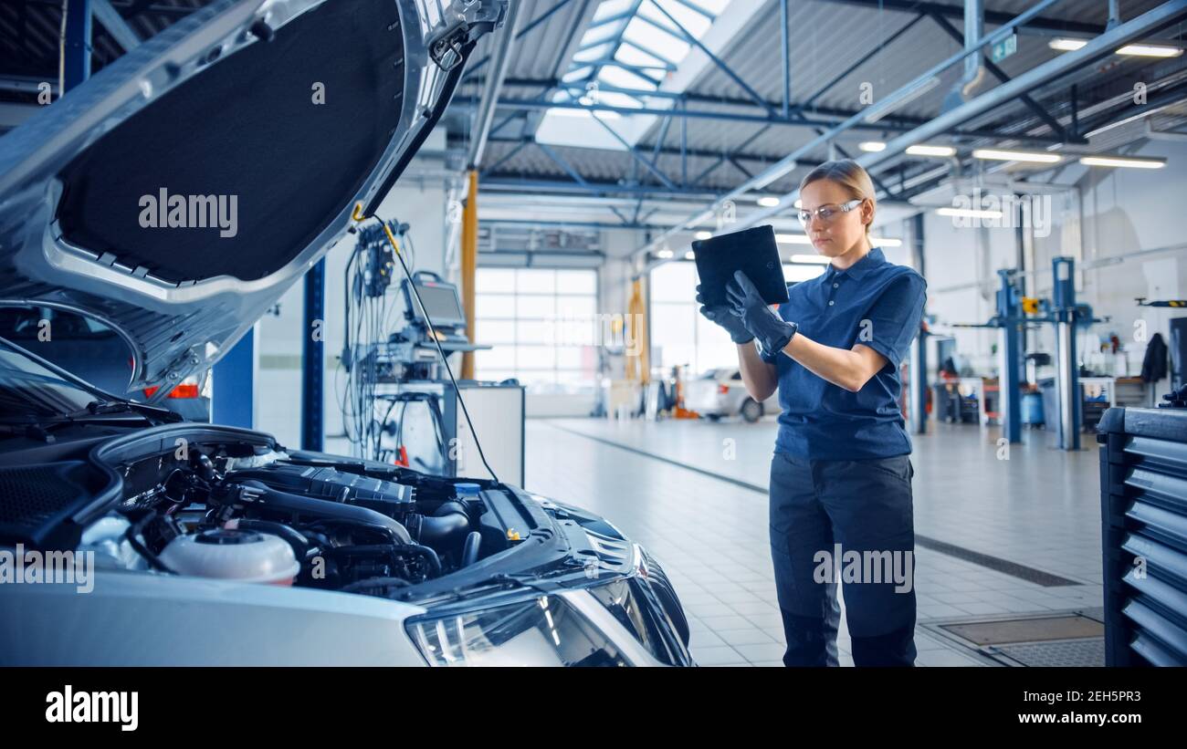Female Mechanic Uses a Tablet Computer with an Augmented Reality  Diagnostics Software. Specialist Inspecting the Car in Order to Find Broken  Stock Photo - Alamy