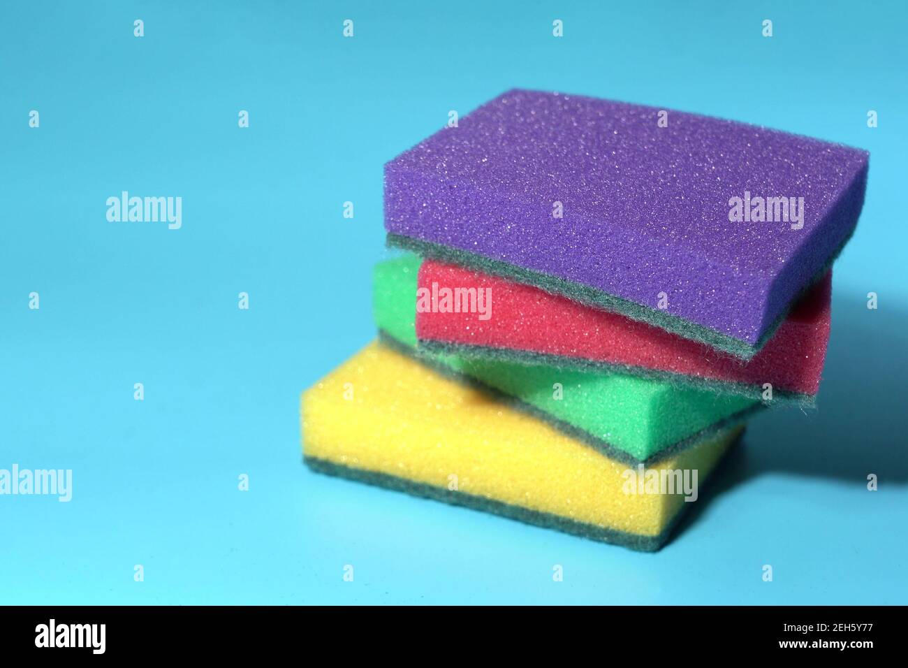 Dishwashing Sponges on a Blue Background Stock Photo