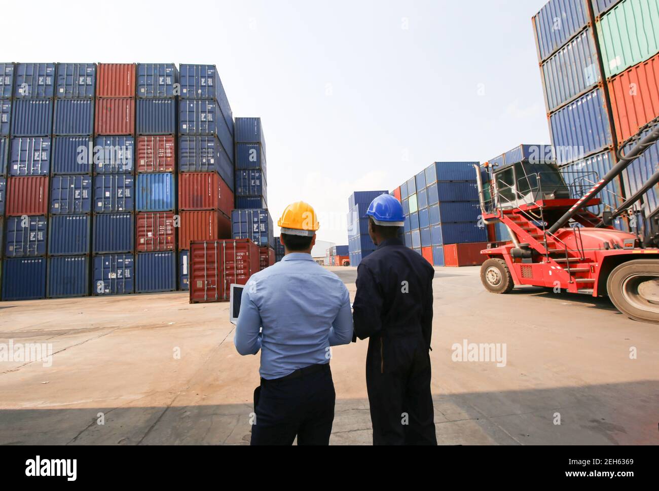 Engineer or supervisor checking and control loading Containers box from ...