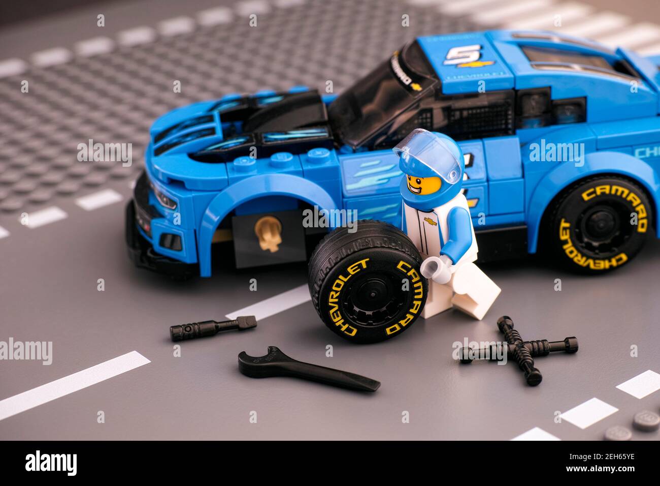 Tambov, Russian Federation - February 14, 2021 Lego driver minifigure  fixing wheel of Chevrolet Camaro ZL1 race car by LEGO Speed Champions. Road  base Stock Photo - Alamy