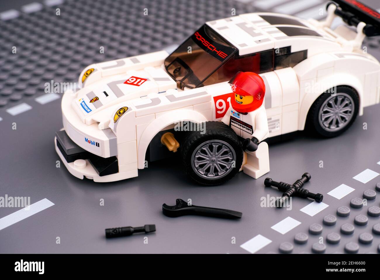 Tambov, Russian Federation - February 14, 2021 Lego driver minifigure  fixing wheel of white Porsche 911 GT by LEGO Speed Champions. Lego road  baseplat Stock Photo - Alamy