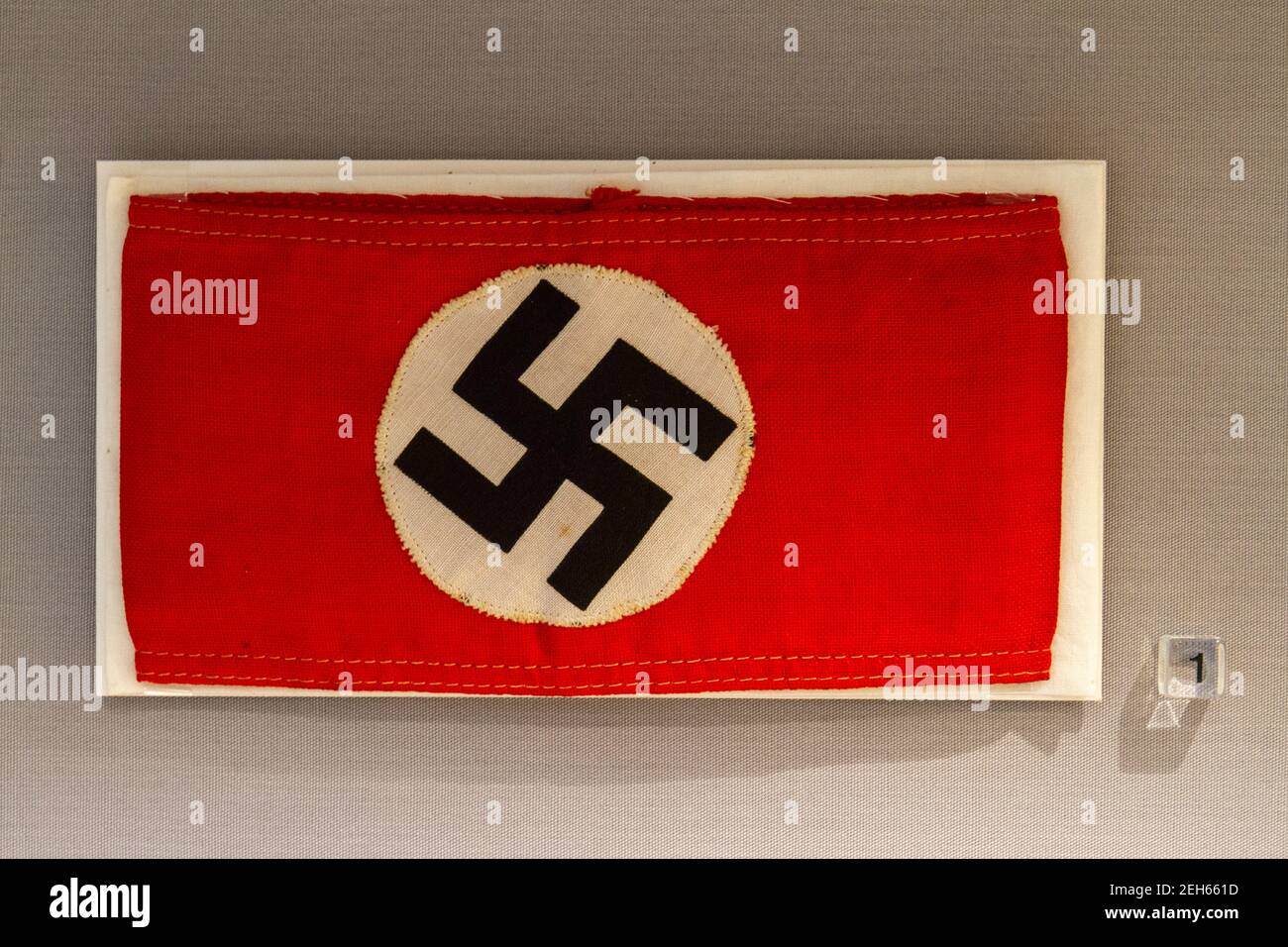 A swastika on a a Nazi German red armband in the REME Museum (Royal Electrical and Mechanical Engineers), Lyneham, Wiltshire, UK. Stock Photo