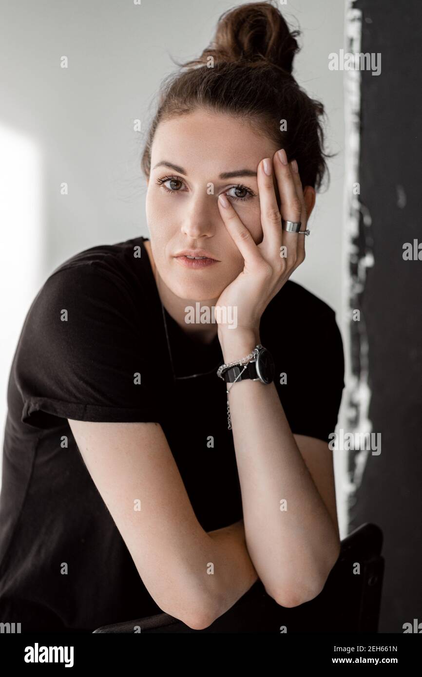Portrait of a beautiful girl in a black shirt on a white background