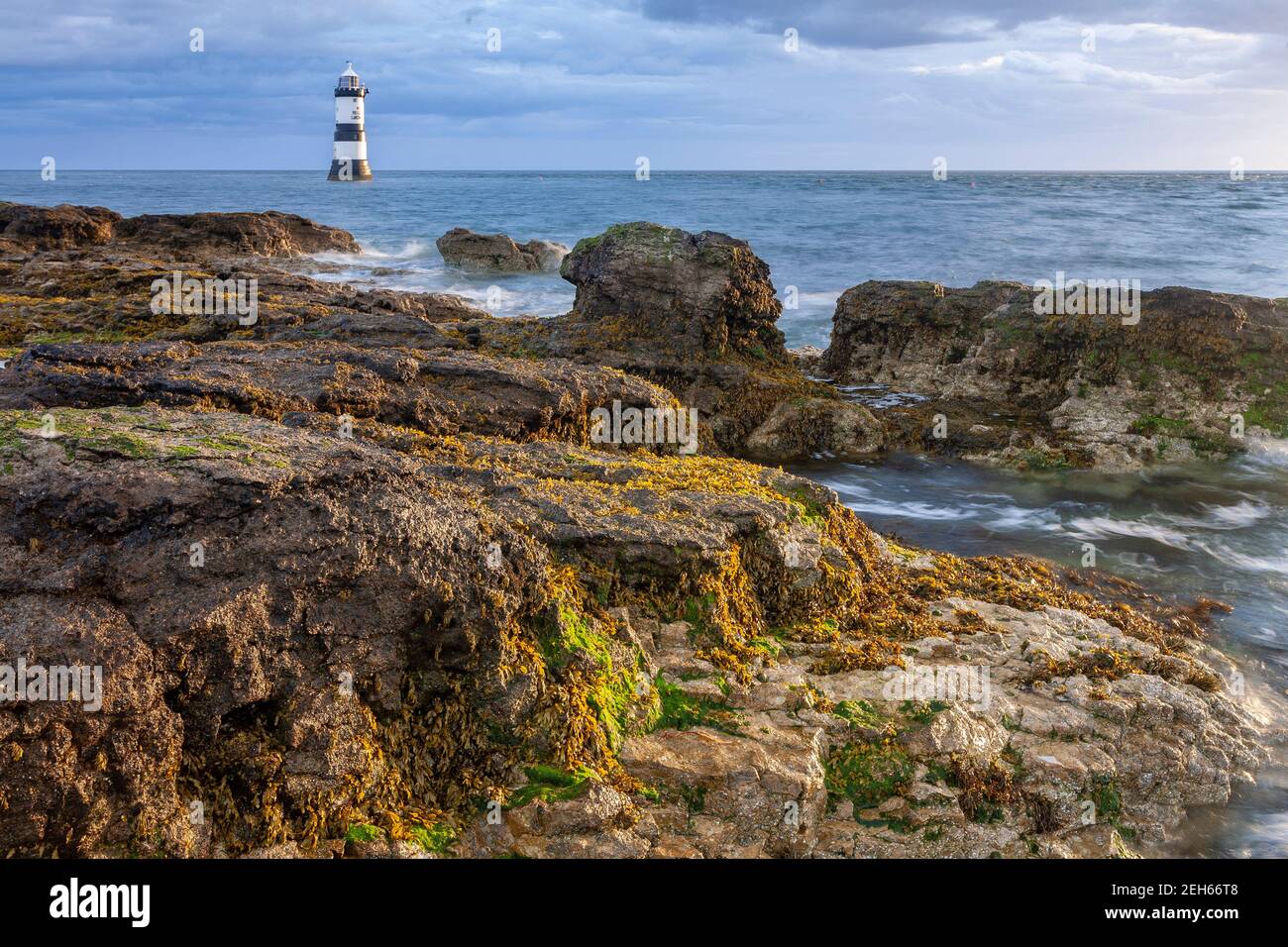 Penmon Point lighthouse in the morning sun, Anglesey, North Wales Stock Photo