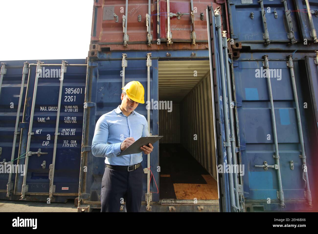 Engineer or supervisor checking and control loading Containers box from ...