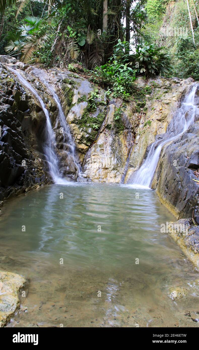 Small Spring Flowing From Rocks Beautiful scene of the spring flowing through rocks into a lake in ...