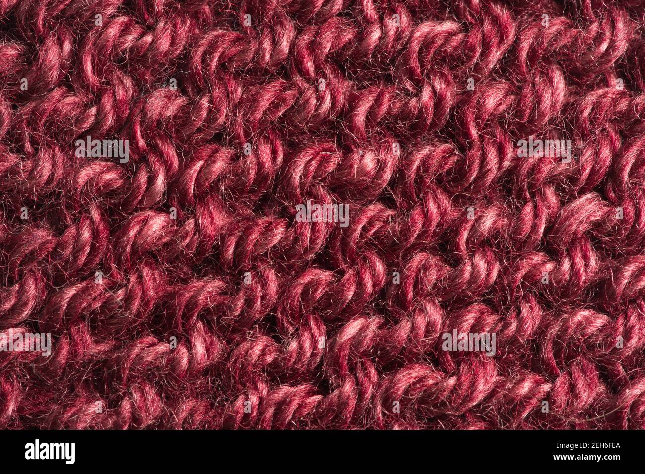 Closeup of red burgundy colored knitted yarn pattern Stock Photo