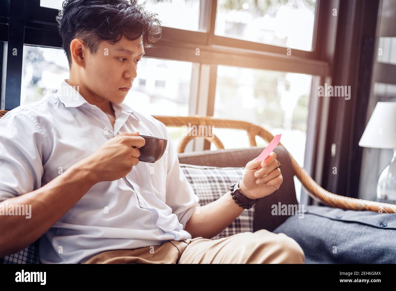 Businessman hold and read sticky note. Stock Photo