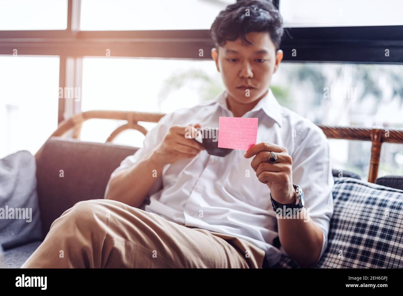 Businessman hold and read sticky note. Stock Photo