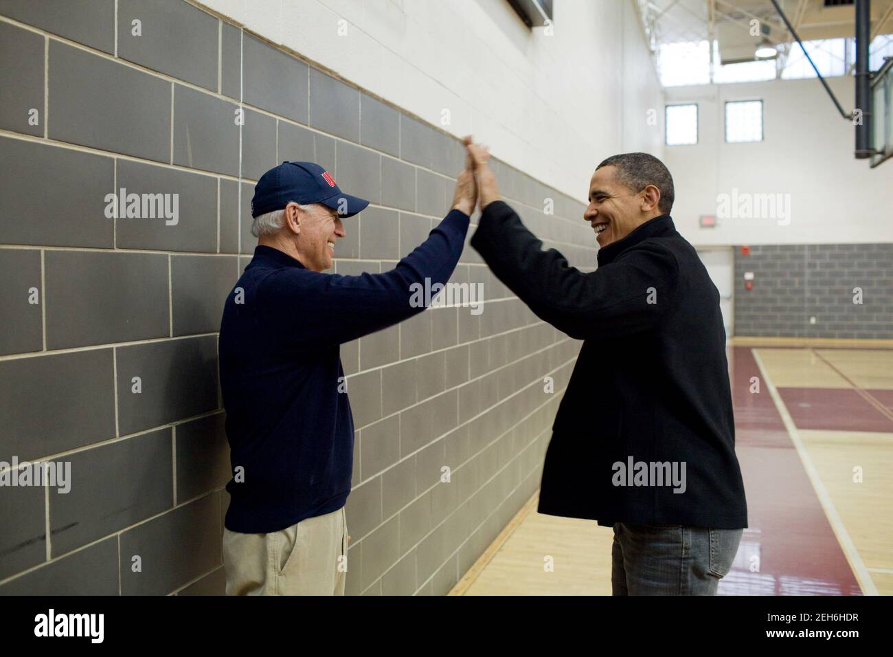 President Barack Obama and Vice President Joe Biden high-five after  watching Sasha Obama and Maisy Biden play in a basketball game in Chevy Chase, Md., Feb. 27, 2010. Stock Photo