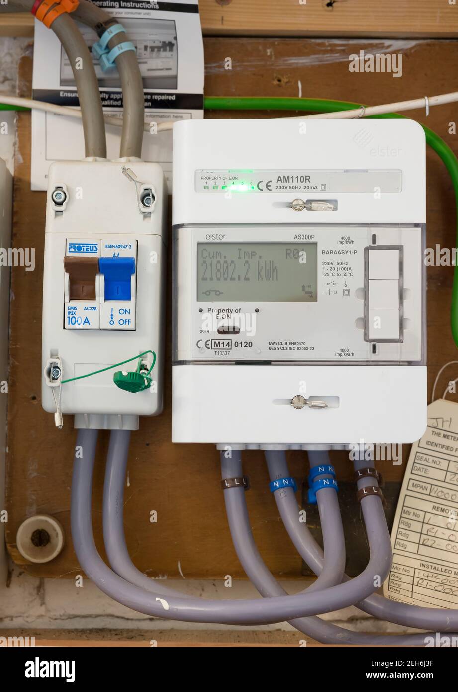 BUCKINGHAM, UK - October 23, 2020. Smart electricity meter, EON domestic electric meter and main switch in a home electric box Stock Photo